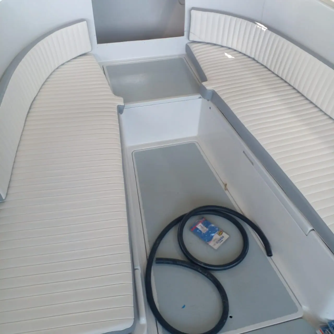Detail of new white cushions in a refinished bow seating area by SXM Refinishing in St. Maarten