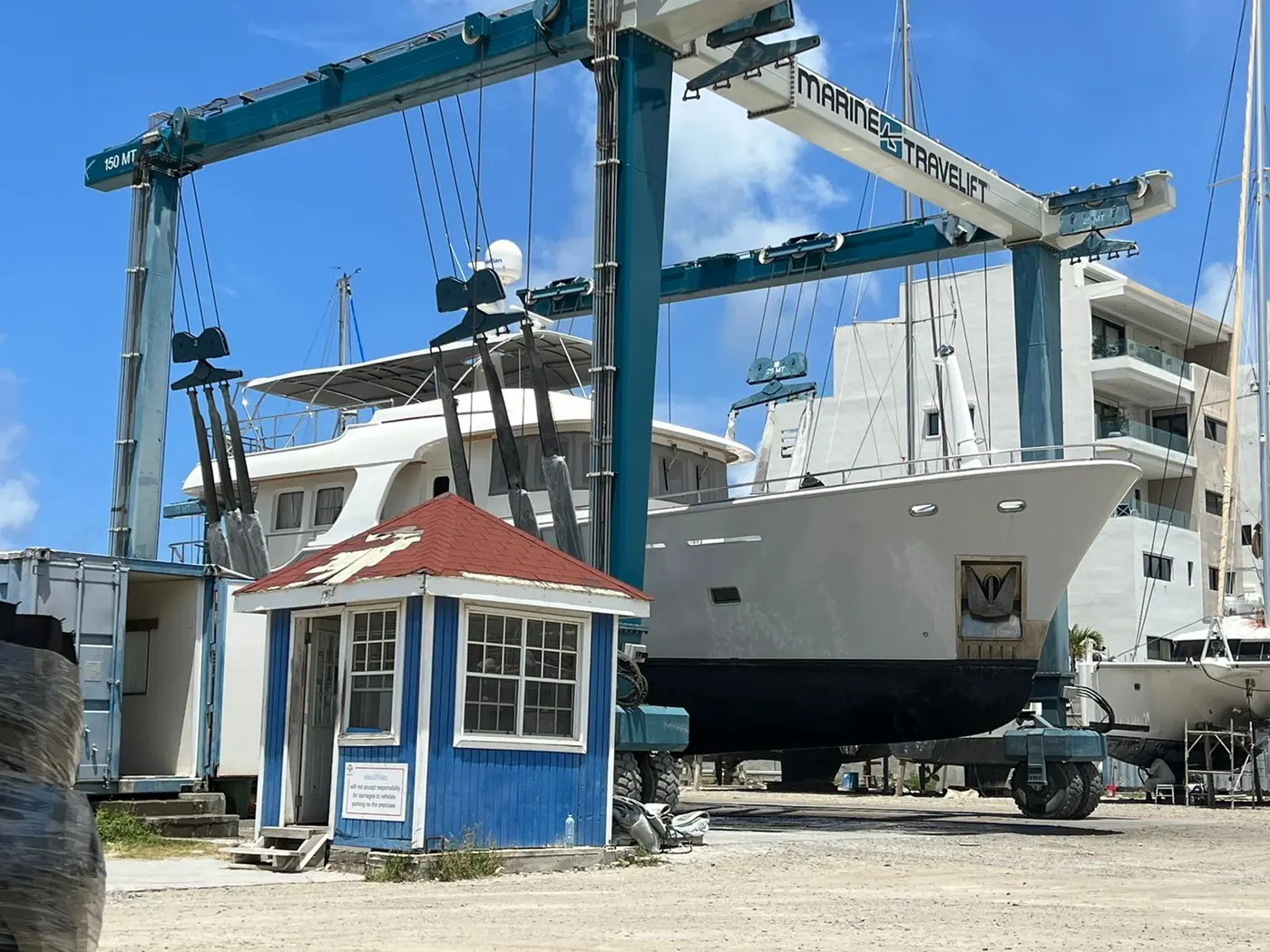 Motor yacht lifted by a 150-tonne travel lift at the boatyard by SXM Refinishing in St. Maarten
