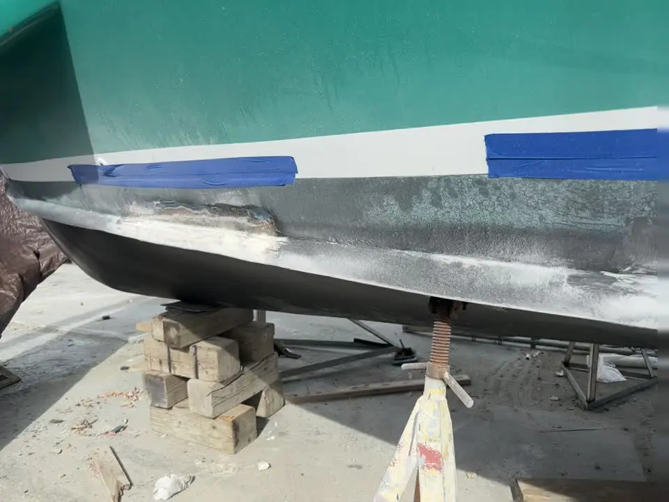 Keel and hull fairing work with fresh filler ready to sand by SXM Refinishing in St. Maarten