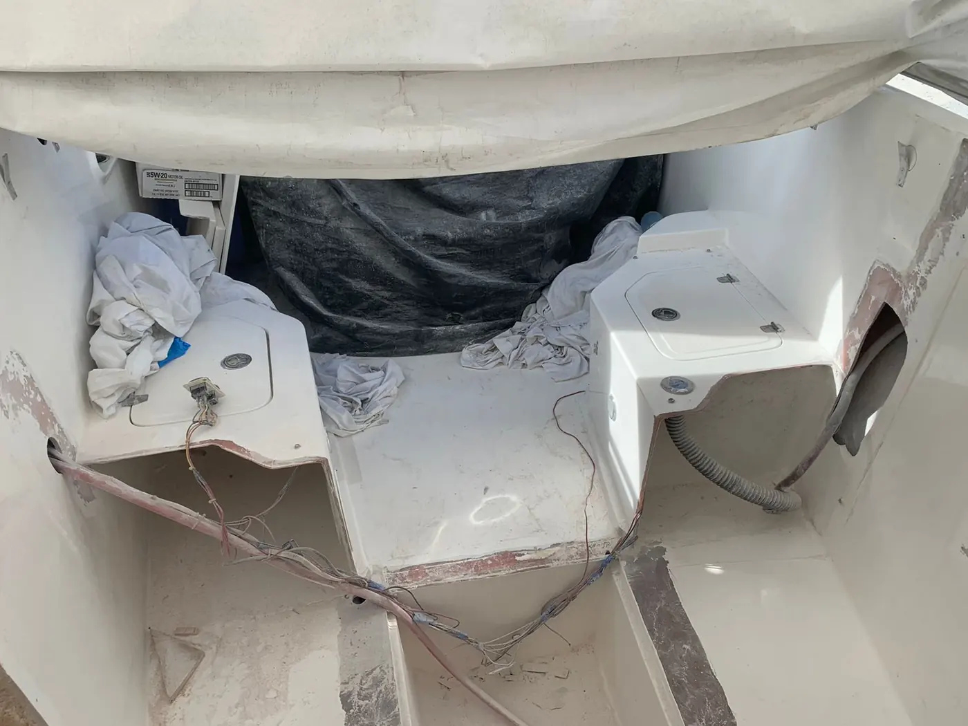 Cockpit lockers stripped back for fiberglass repair by SXM Refinishing in St. Maarten